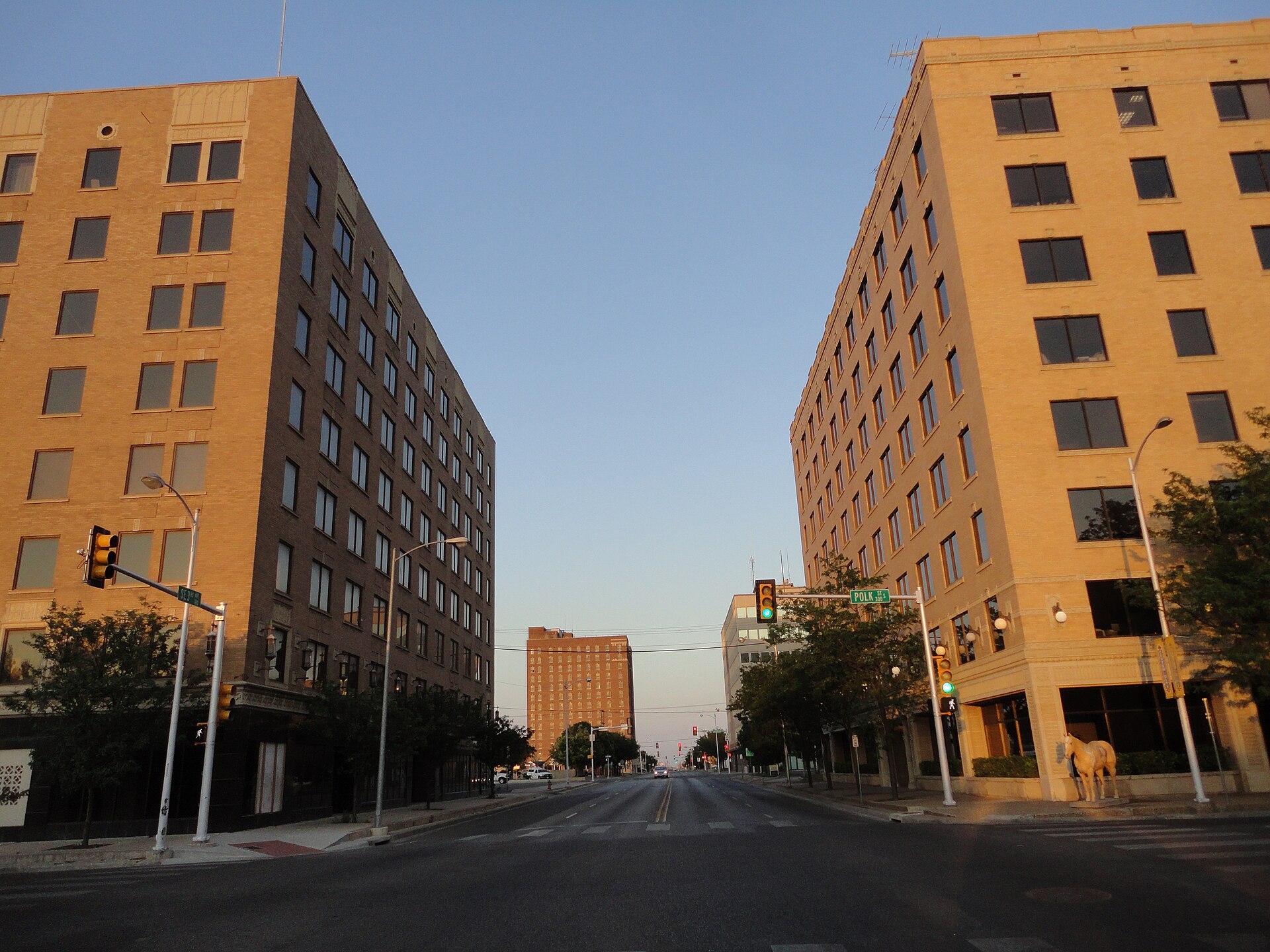 Two brick high-rises frame Polk Street in downtown Amarillo in the late-afternoon sun.
