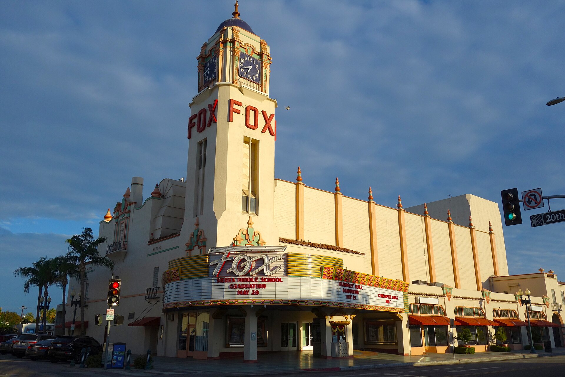 The Fox Theater's clock tower and marquee glowing in late-afternoon sun on a downtown street corner in Bakersfield.