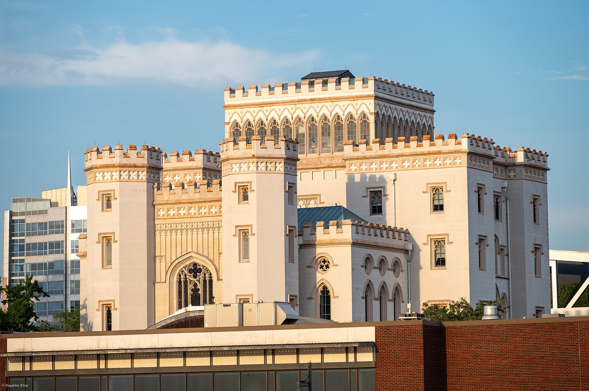 The white Gothic Revival Old Louisiana State Capitol, with its castle-like turrets, in warm sunlight in downtown Baton Rouge.