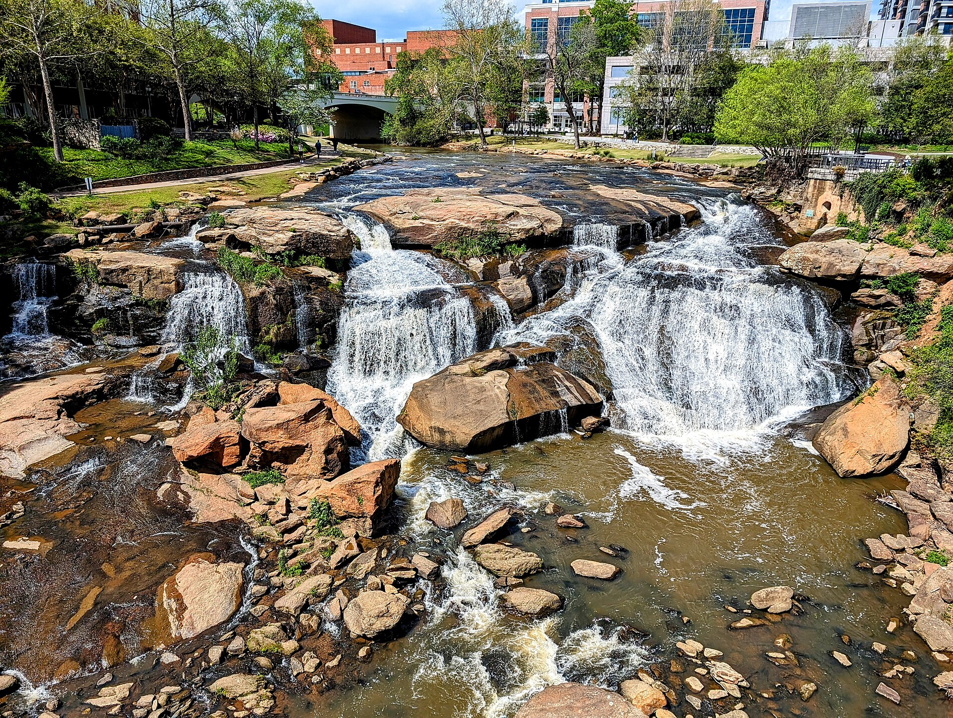 Water cascading over the rocks of Reedy River Falls in Falls Park, downtown Greenville, on a spring day.