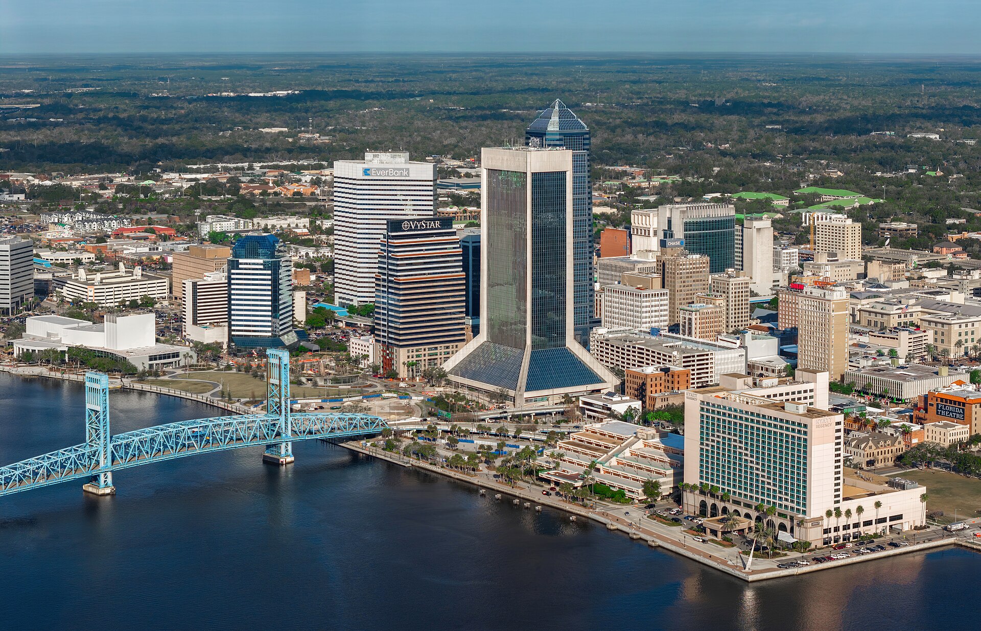 Downtown Jacksonville's towers and the blue Main Street Bridge over the St. Johns River on a clear day.