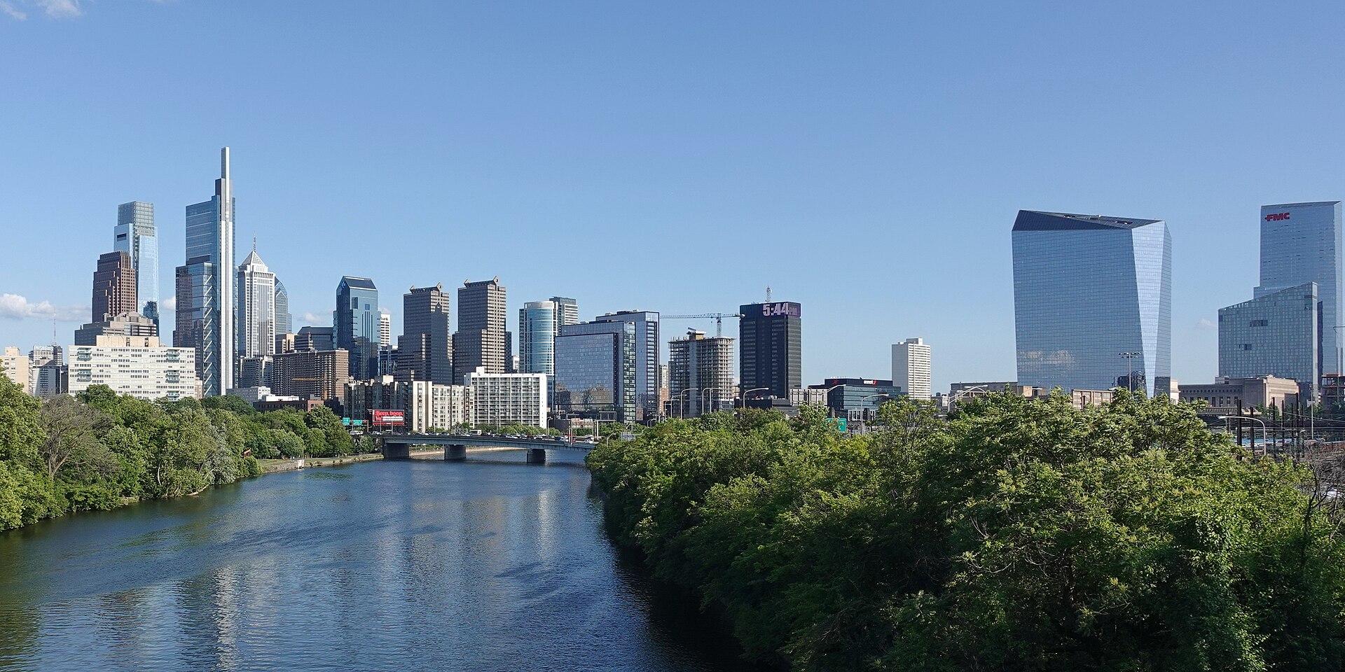 The Philadelphia skyline rising beyond the Schuylkill River and its wooded banks.
