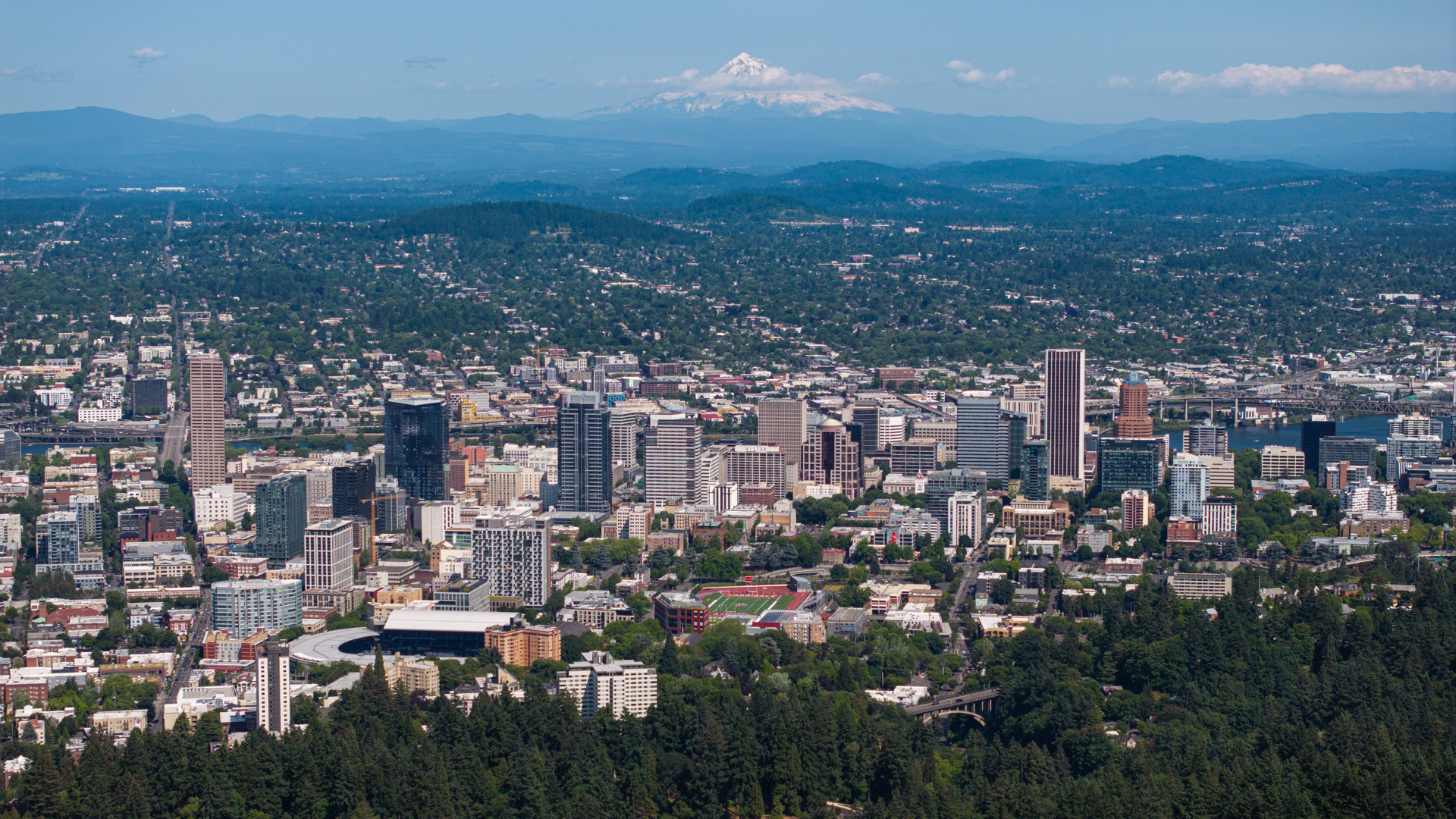 Downtown Portland and its green hills, with Mount Hood on the horizon.