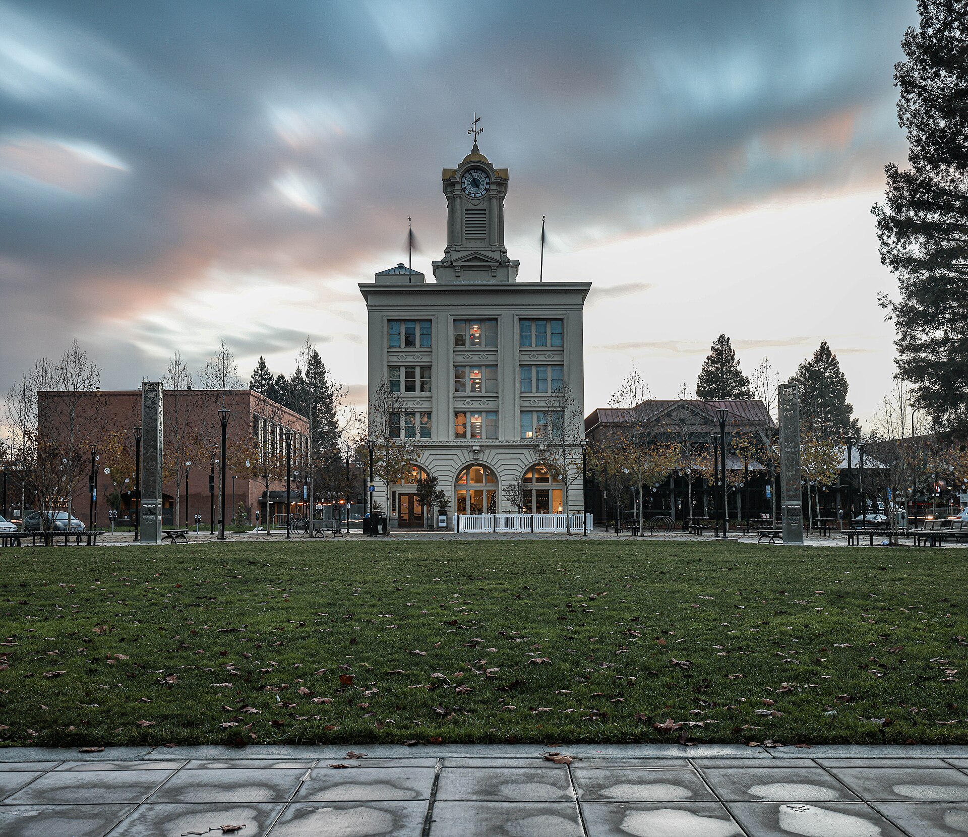 The Empire Building's clock tower above Old Courthouse Square in downtown Santa Rosa under a streaky evening sky.