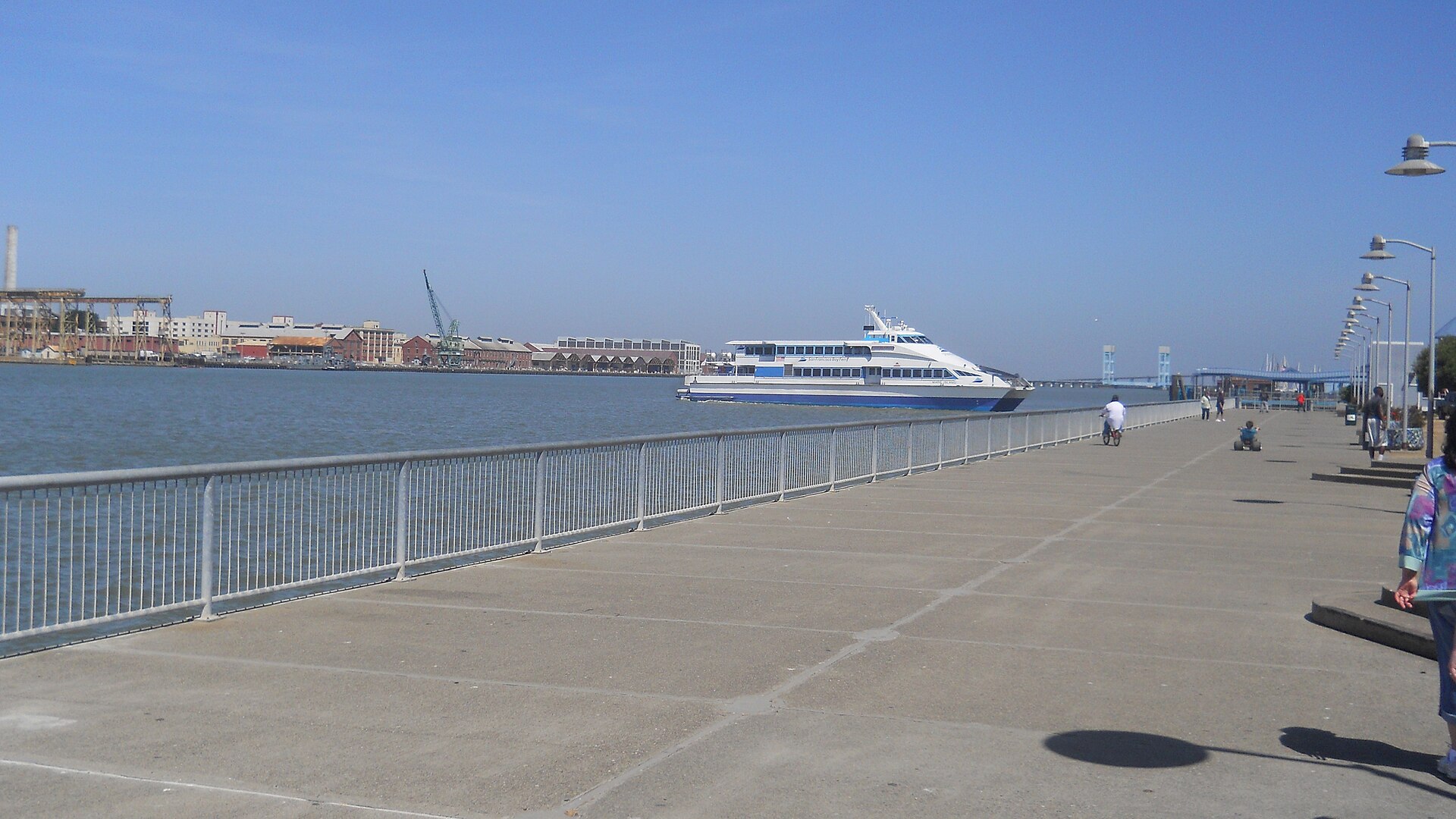 A ferry crossing the Mare Island Strait beside the Vallejo waterfront promenade on a sunny day.
