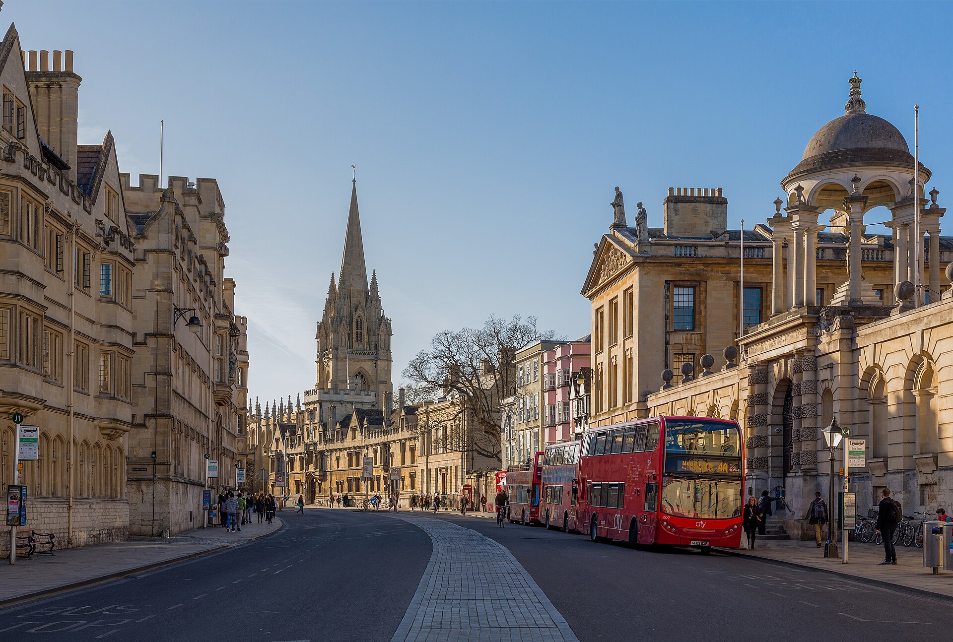 View west along part of High Street, Oxford. The Queen's College is on the right. All Souls' College and the tower and spire of the University Church of St Mary
